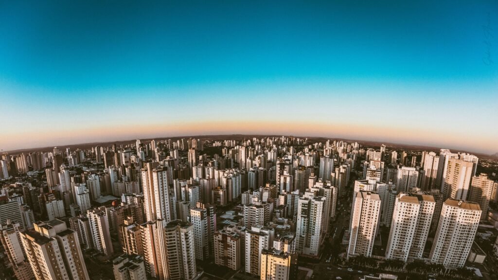An aerial view of the city buildings under blue sky